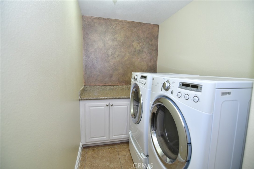 3 Ei Corzo Rancho Santa Margarita, CA 92688 - Photo 10 of 31 a utility room with dryer and washer