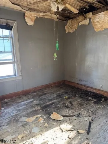 a view of a room with wooden floor and windows