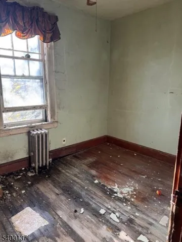 a bath room with a toilet a bath tub and a window