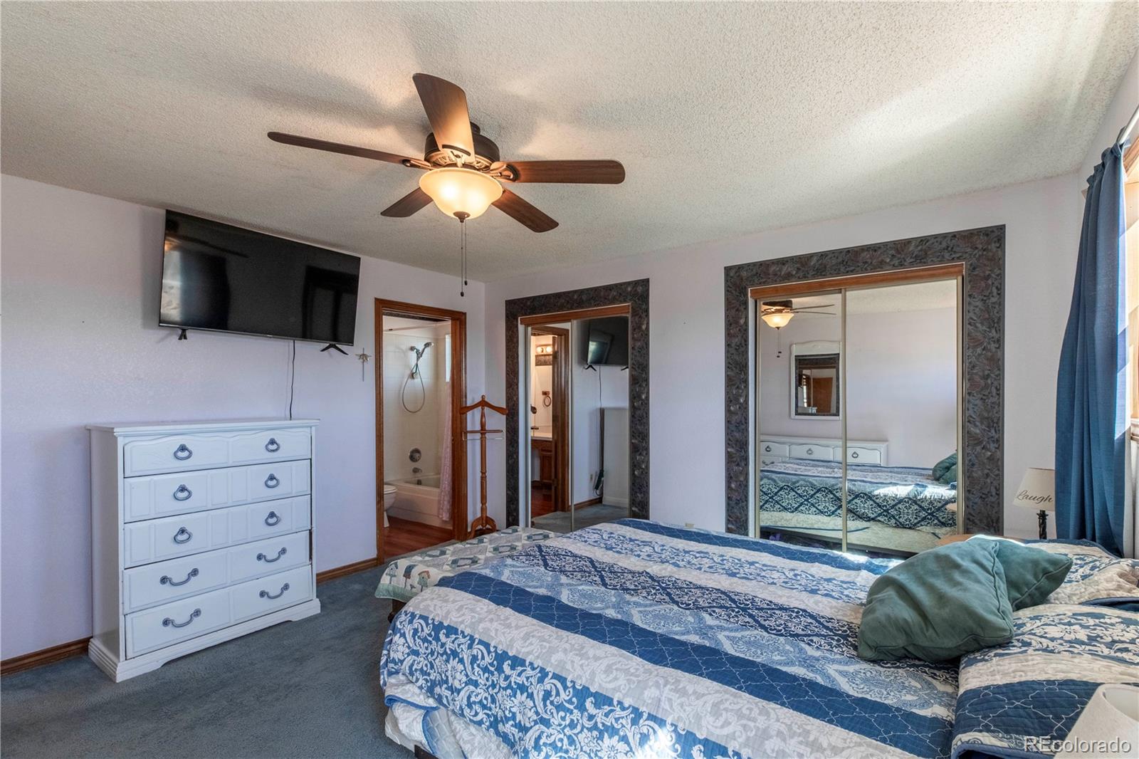 2141 Remington Road Elizabeth, CO 80107 - Photo 11 of 42 a bedroom with a bed a flat screen tv and dresser