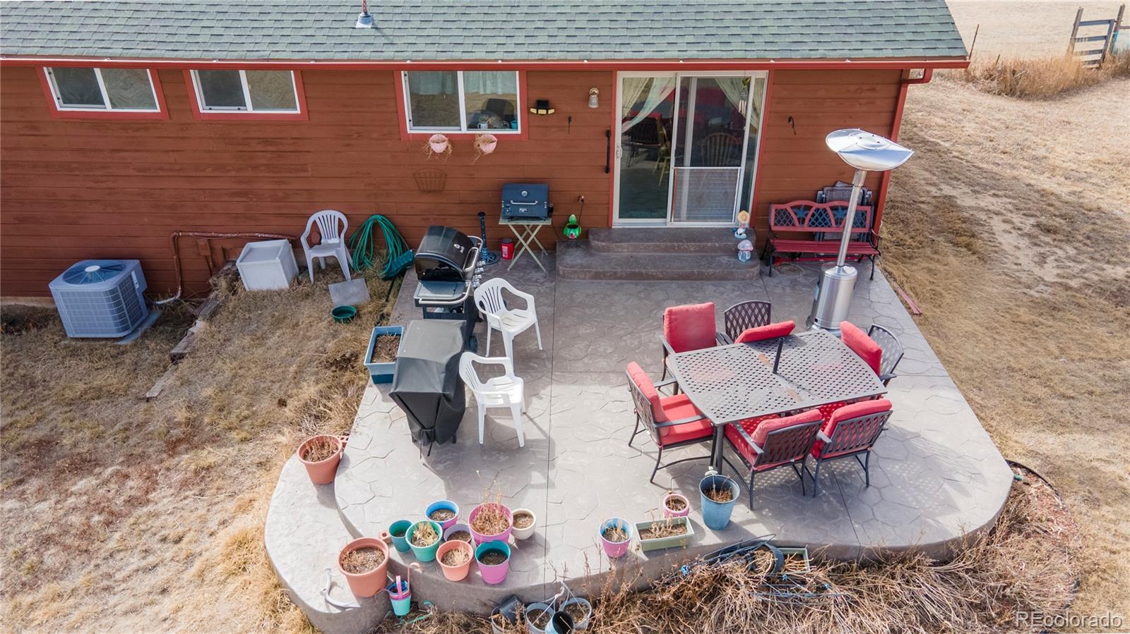 2141 Remington Road Elizabeth, CO 80107 - Photo 34 of 42 an outdoor living area with furniture and a fireplace