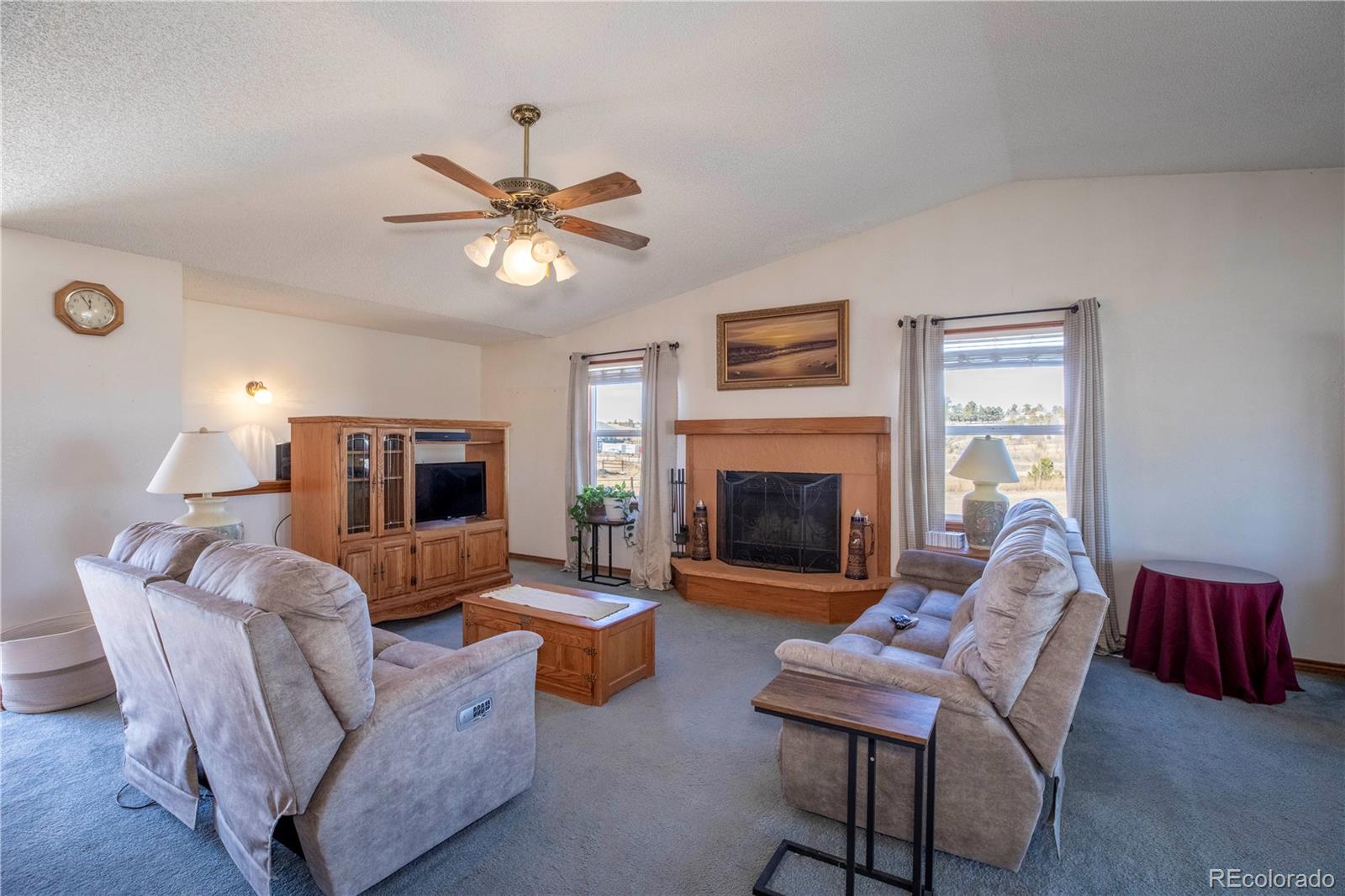 2141 Remington Road Elizabeth, CO 80107 - Photo 4 of 42 a living room with furniture a fireplace and a flat screen tv