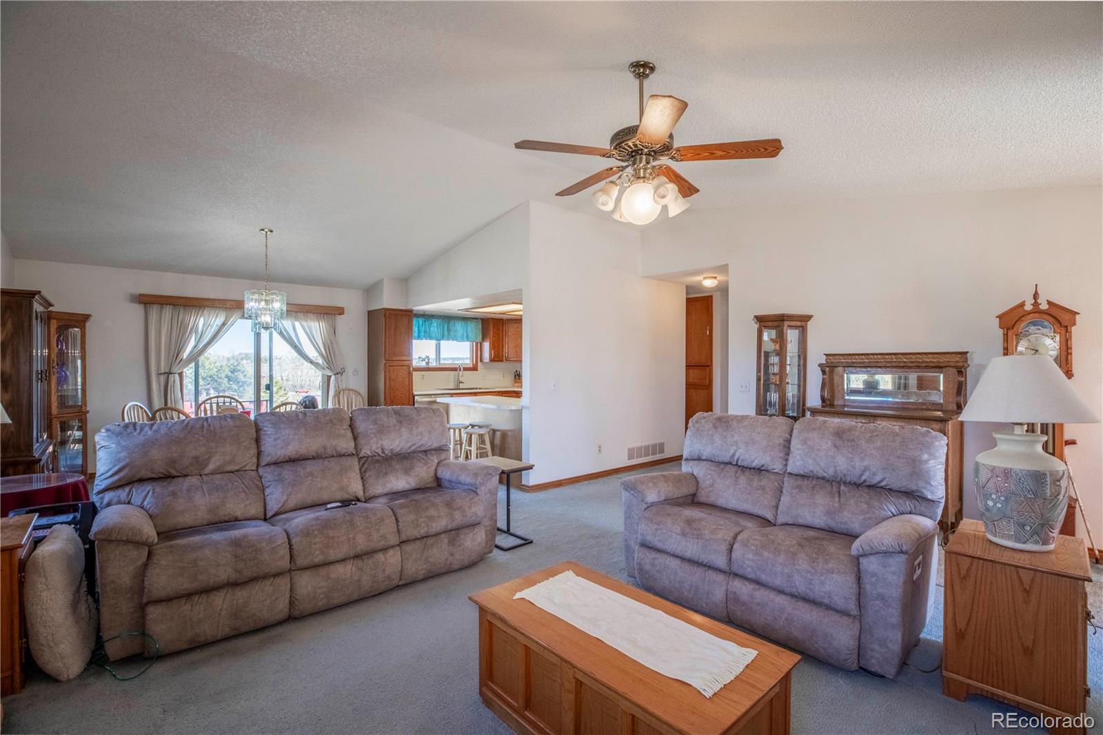 2141 Remington Road Elizabeth, CO 80107 - Photo 5 of 42 a living room with furniture a ceiling fan and a window