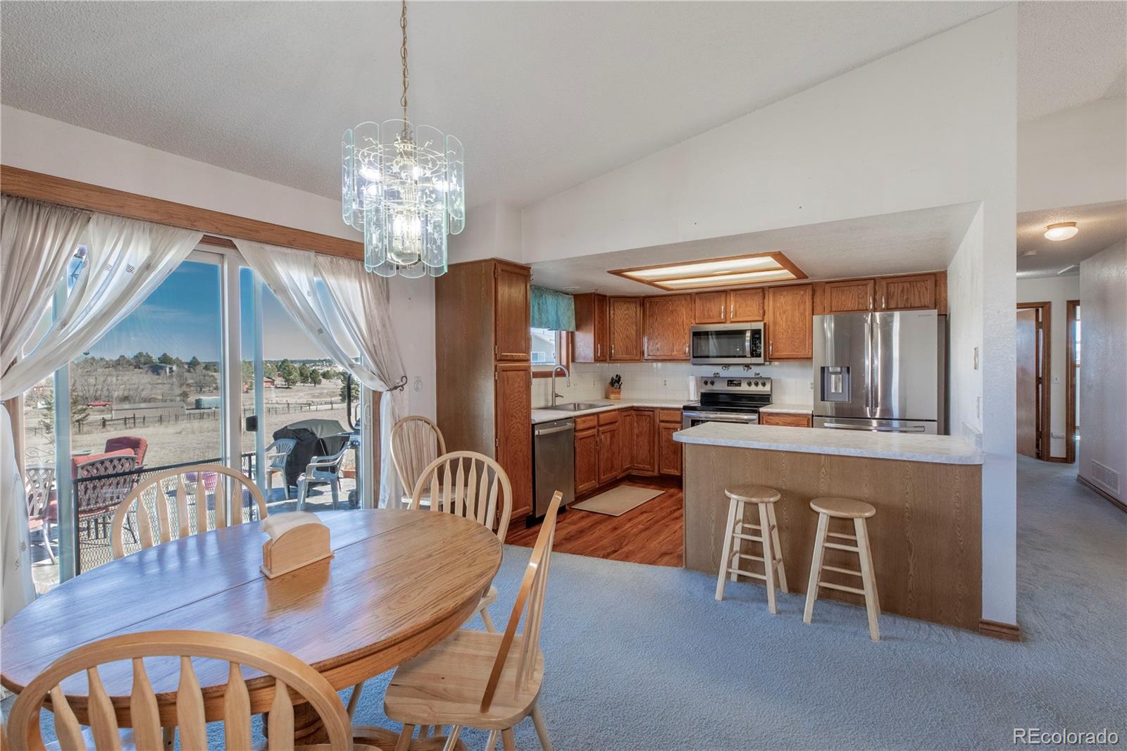 2141 Remington Road Elizabeth, CO 80107 - Photo 6 of 42 a dining room with furniture a chandelier and wooden floor