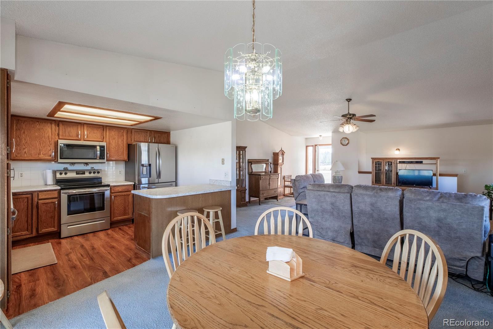 2141 Remington Road Elizabeth, CO 80107 - Photo 7 of 42 a view of a dining room with furniture a chandelier and wooden floor
