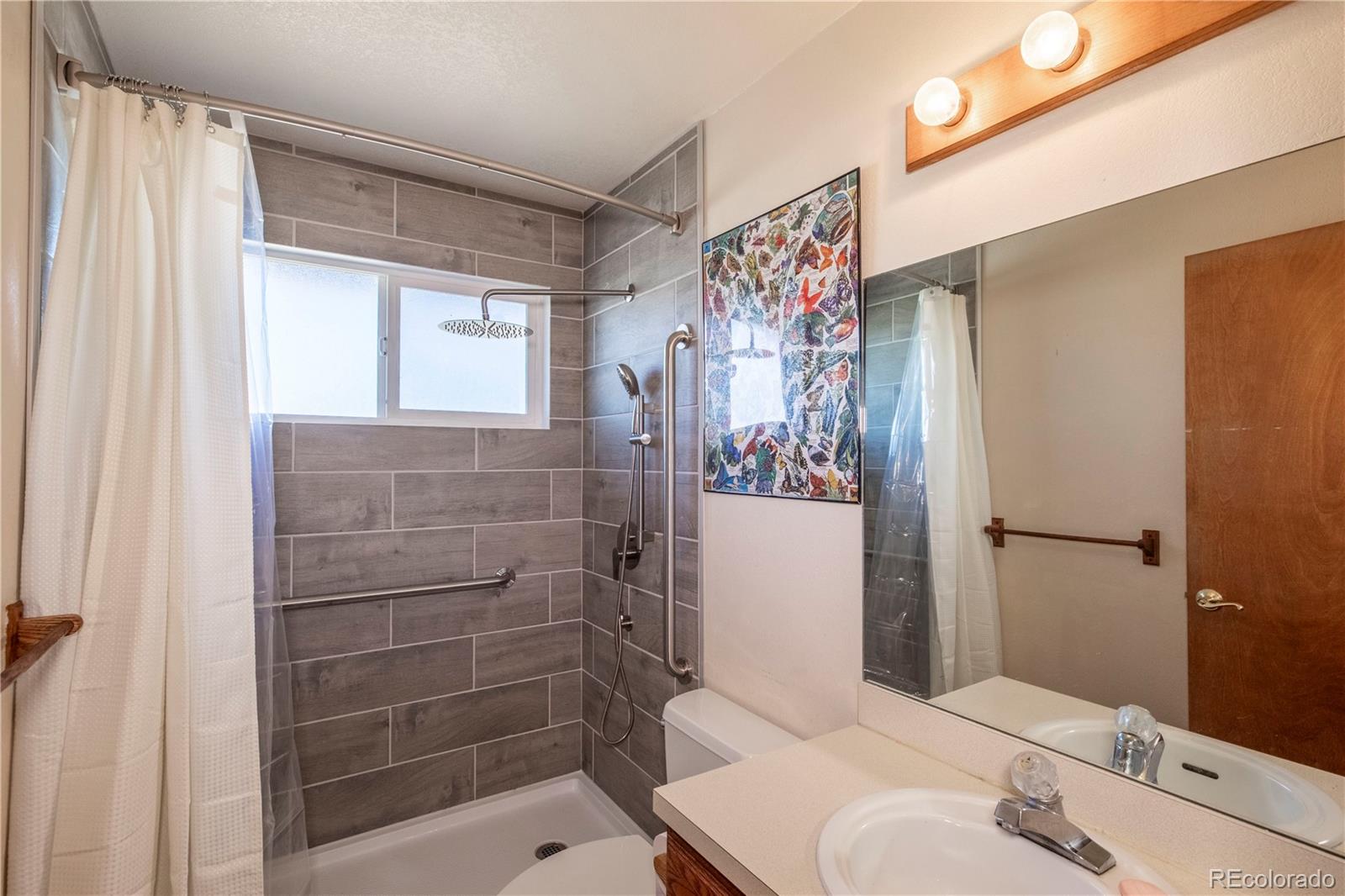 2141 Remington Road Elizabeth, CO 80107 - Photo 9 of 42 a bathroom with a shower toilet and sink