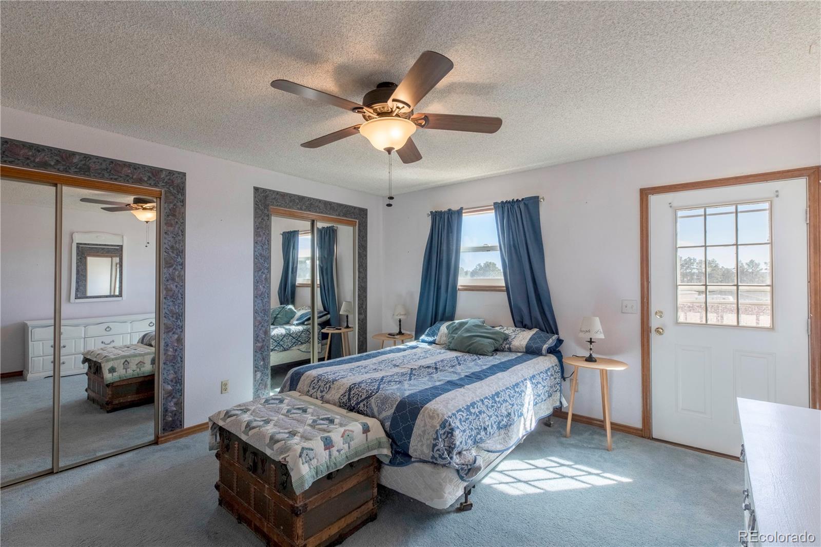 2141 Remington Road Elizabeth, CO 80107 - Photo 10 of 42 a bedroom with a bed couch and window