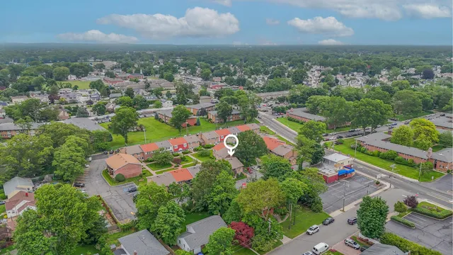 an aerial view of residential houses with outdoor space and street view