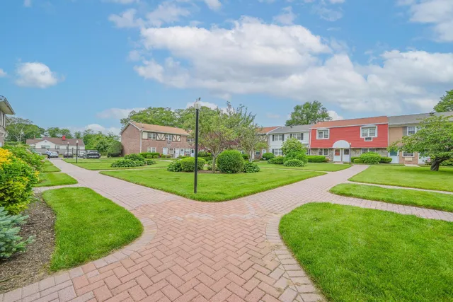 a view of a garden with a building in the background