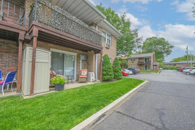 a front view of a house with a yard and table and chairs