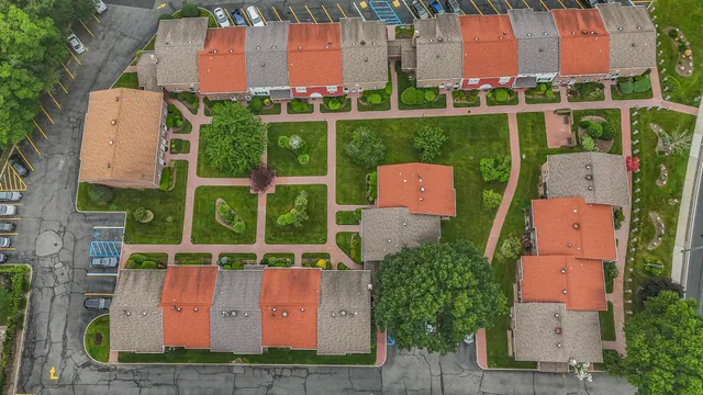 an aerial view of a house with a garden and yard