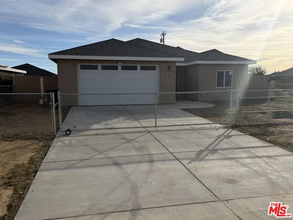 a kitchen with stainless steel appliances wooden floor and white cabinets