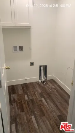 a view of storage and utility room with wooden floor