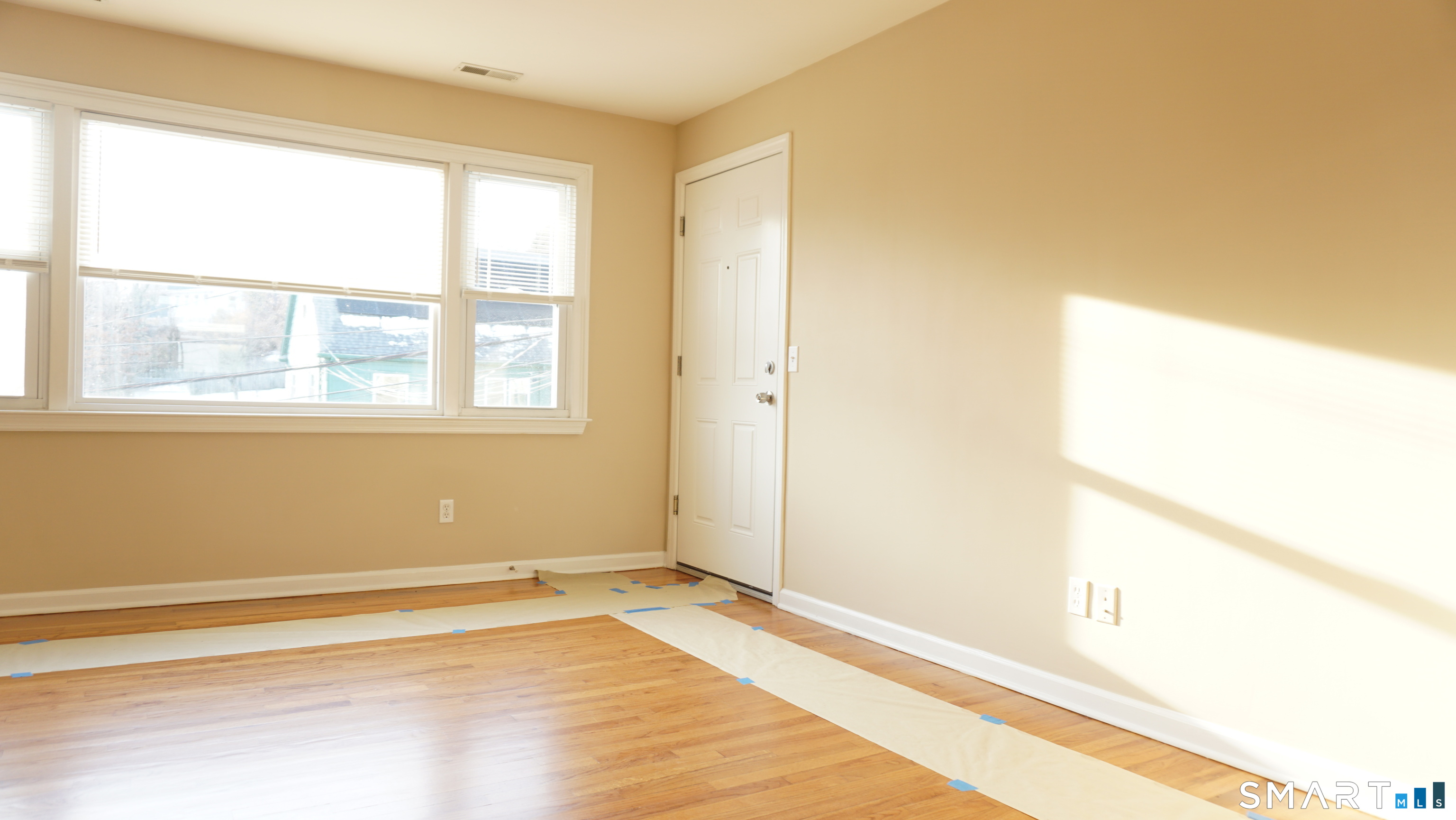 28 Sampson Street, Unit 4 Bridgeport, CT 06606 - Photo 11 of 30 a view of an empty room with wooden floor and a window