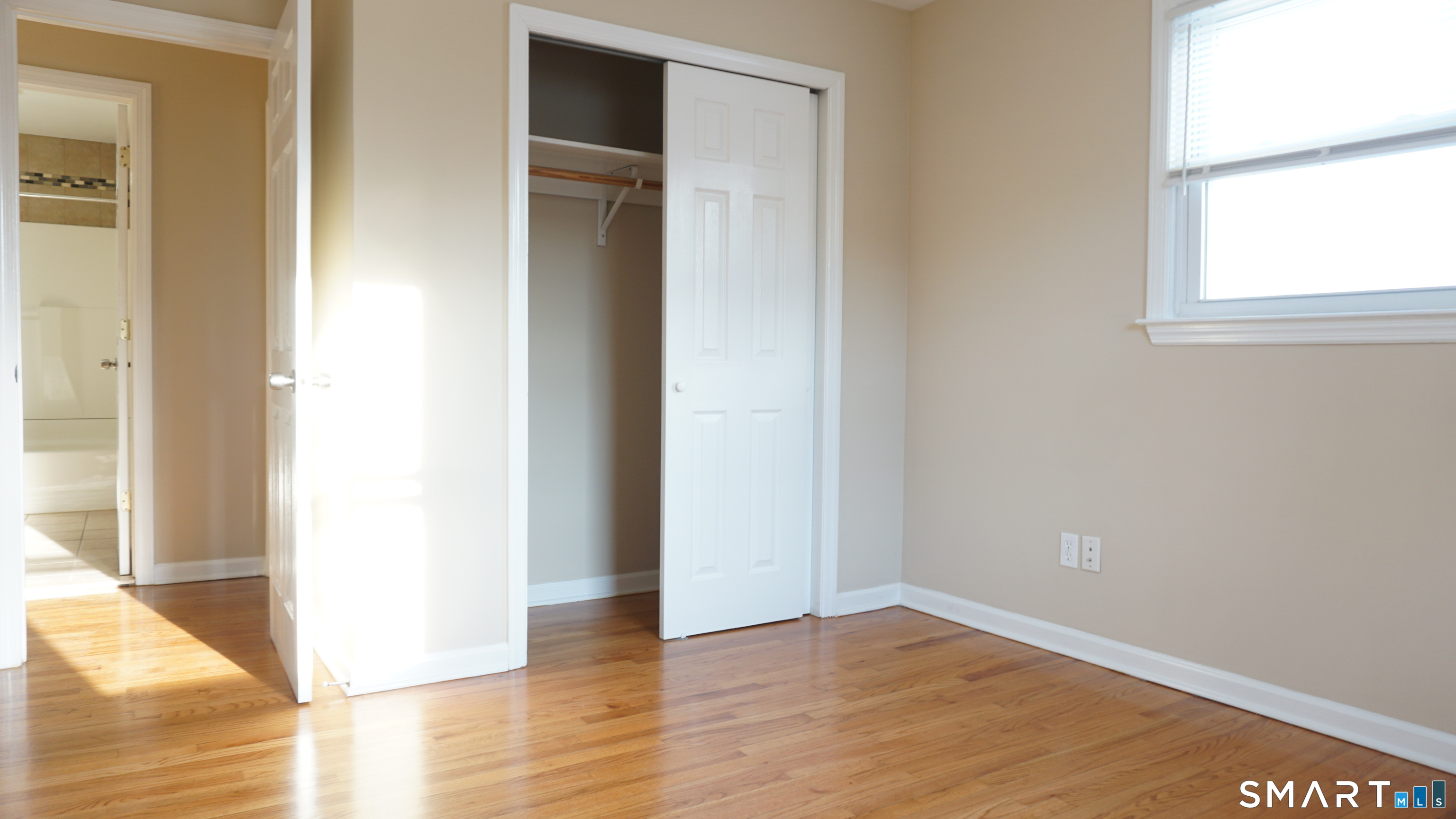 28 Sampson Street, Unit 4 Bridgeport, CT 06606 - Photo 14 of 30 a view of an empty room with wooden floor and a window