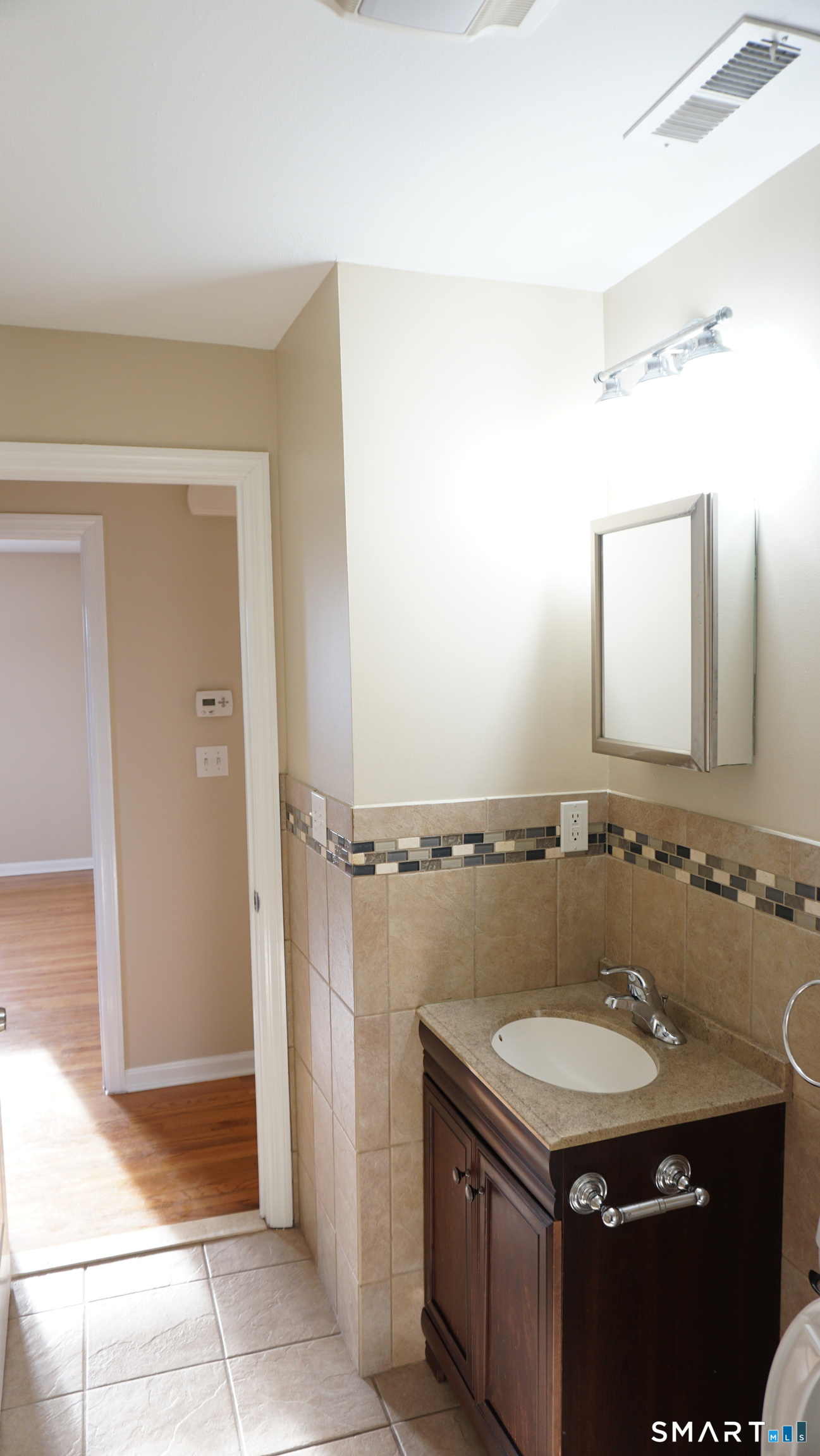 28 Sampson Street, Unit 4 Bridgeport, CT 06606 - Photo 6 of 30 a bathroom with a granite countertop sink a mirror and a shower