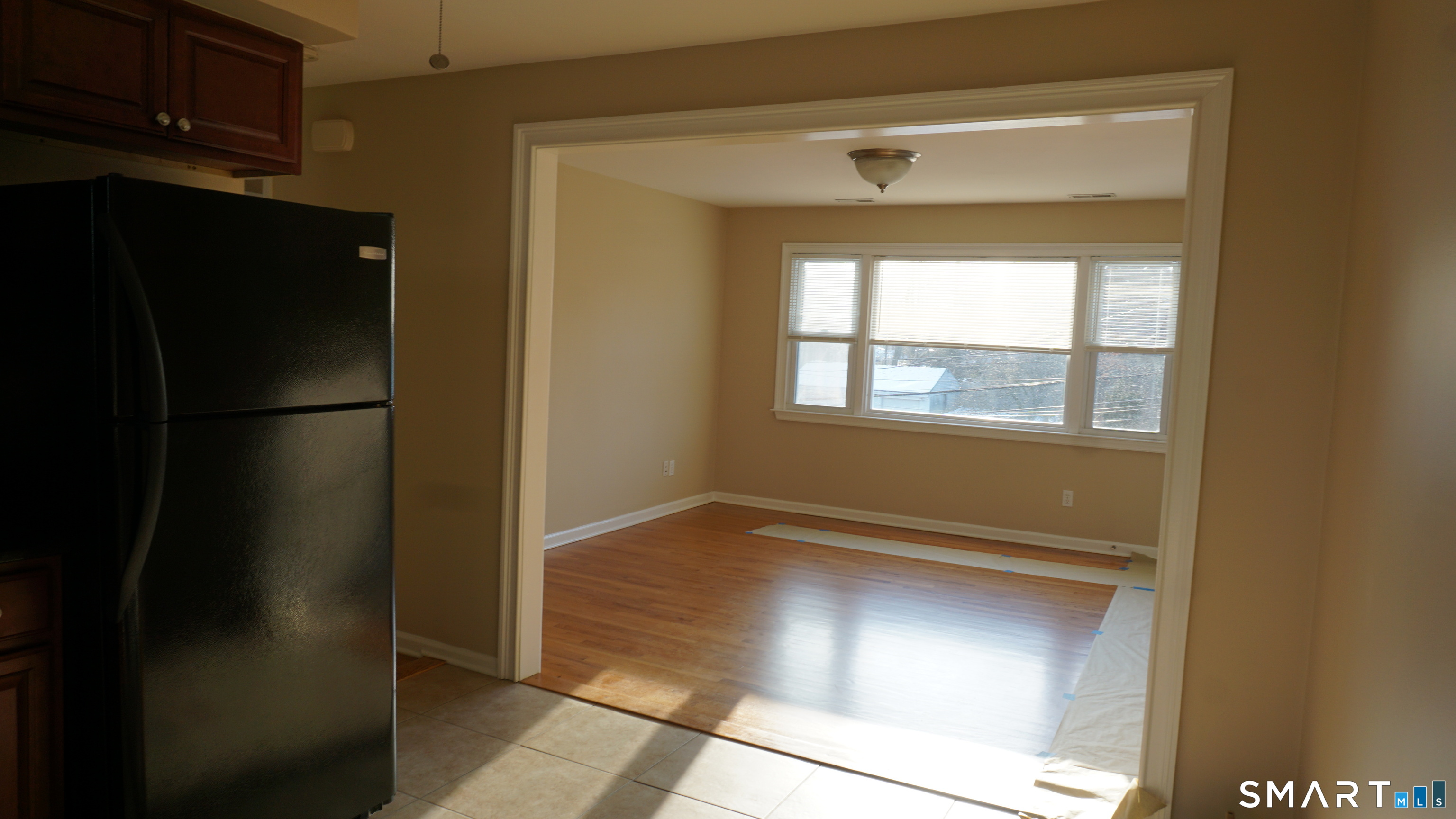 28 Sampson Street, Unit 4 Bridgeport, CT 06606 - Photo 9 of 30 a view of an empty room with wooden floor and a window