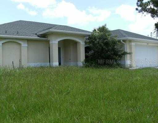 5293 Cromey Road North Port, FL 34288 - Photo 1 of 1 a front view of a house with a garden