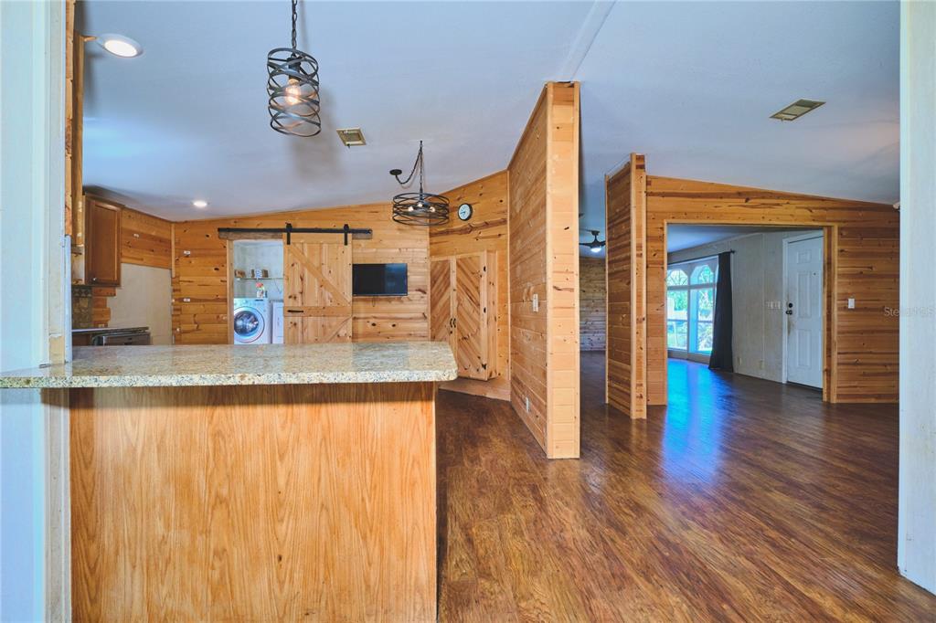 2701 Murphy Road Ona, FL 33865 - Photo 16 of 41 a view of a living room and kitchen with wooden floor