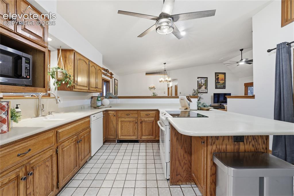 18190 Forest View Road Monument, CO 80132 - Photo 3 of 50 a kitchen with a sink appliances and cabinets