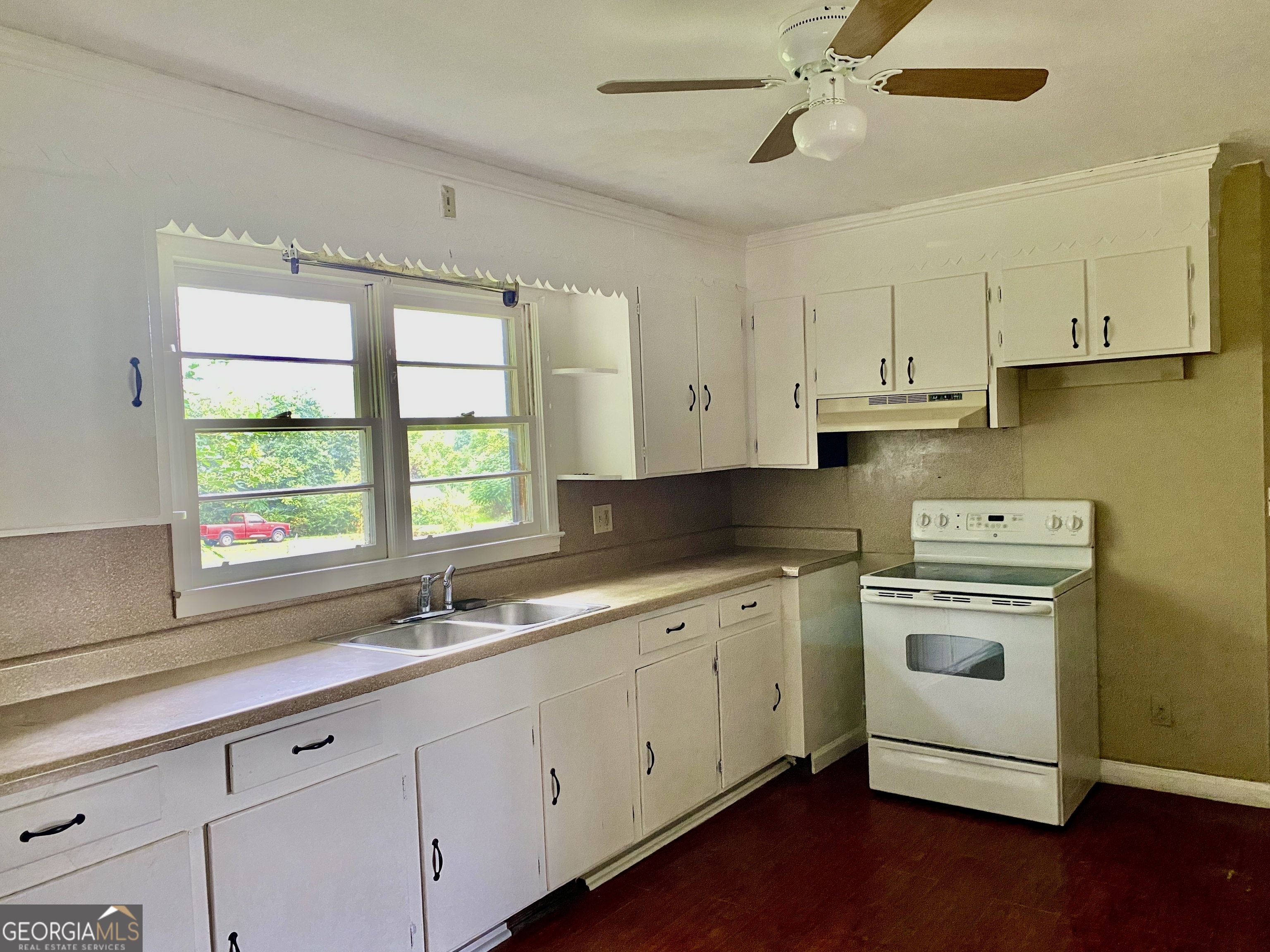 514 Booze Mountain Road Southeast Lindale, GA 30161 - Photo 3 of 13 a kitchen with a sink stove and cabinets