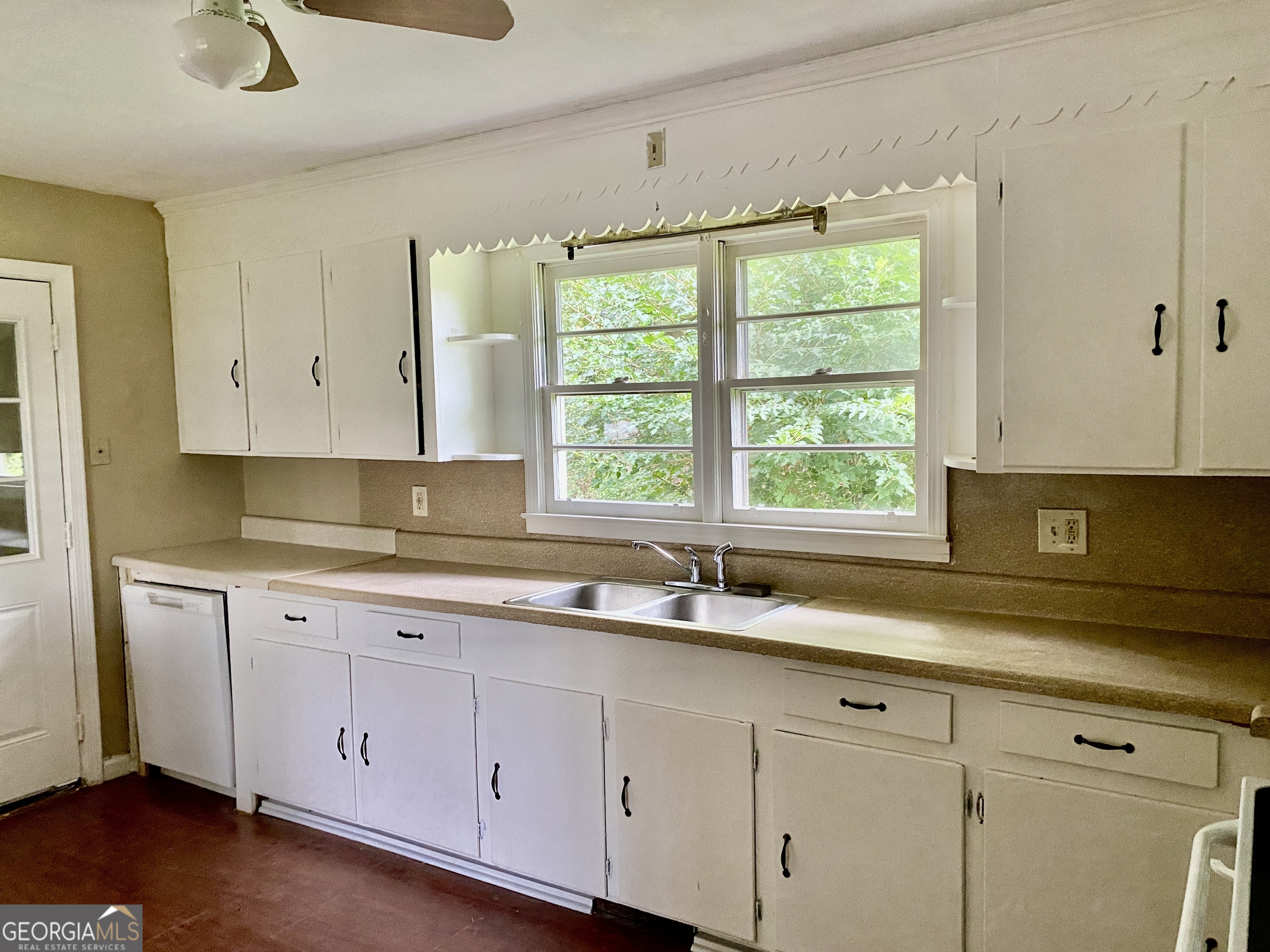 514 Booze Mountain Road Southeast Lindale, GA 30161 - Photo 4 of 13 a kitchen with white cabinets and a window