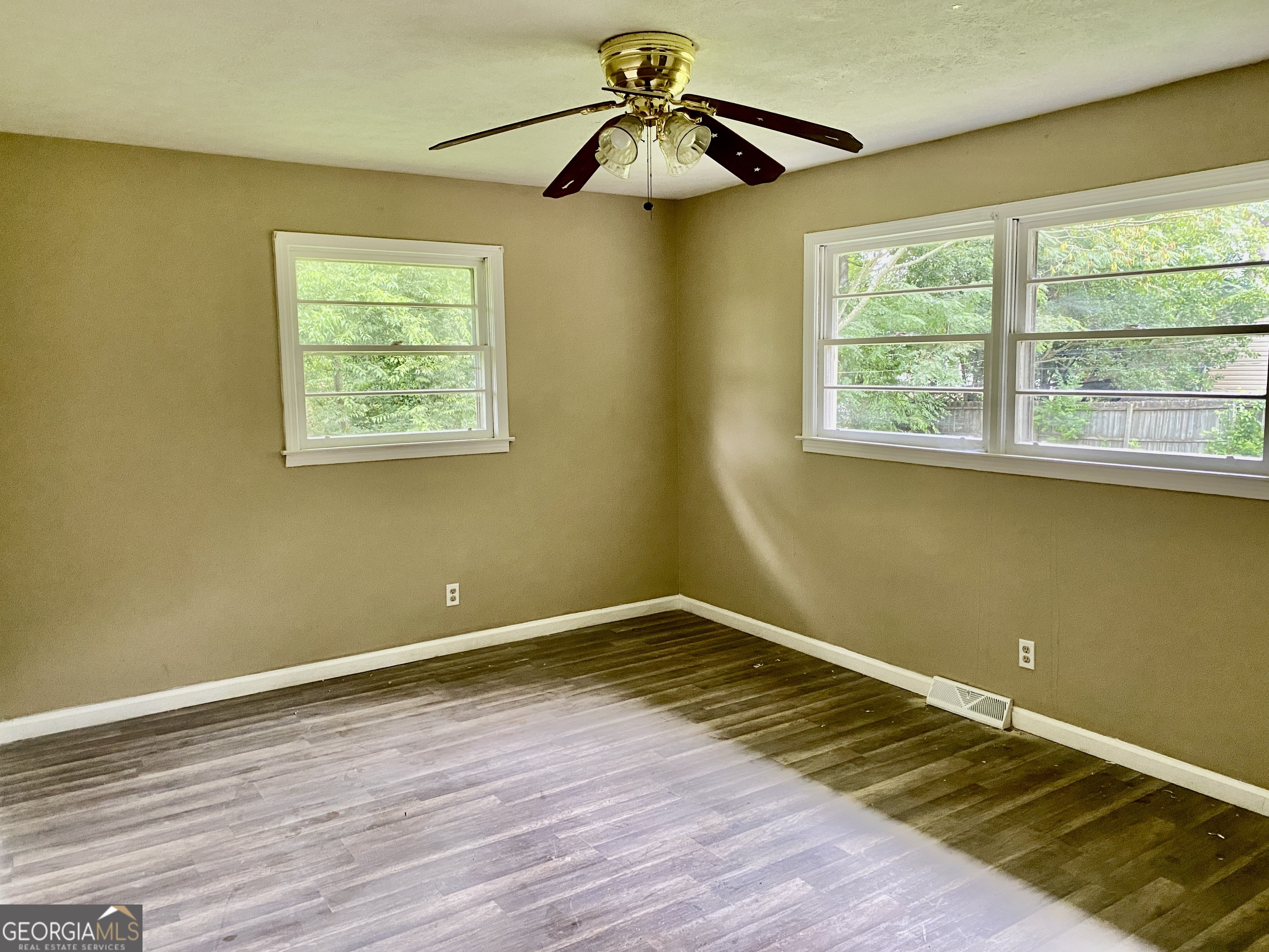 514 Booze Mountain Road Southeast Lindale, GA 30161 - Photo 9 of 13 a view of empty room with wooden floor and fan