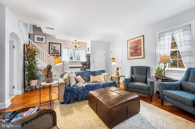 a living room with furniture ceiling fan and a window