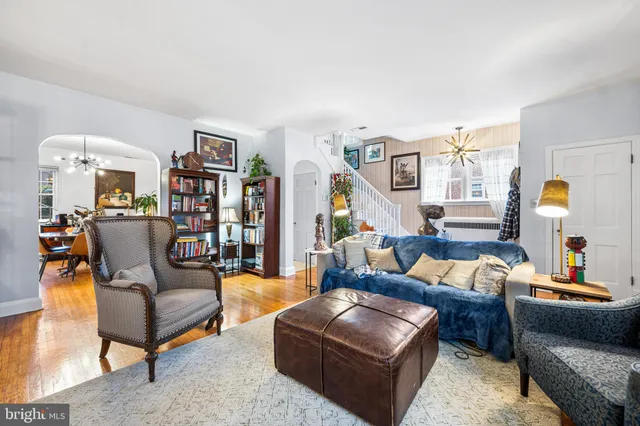 a living room with furniture and a lamp