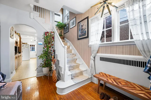 a view of a entryway with furniture and wooden floor