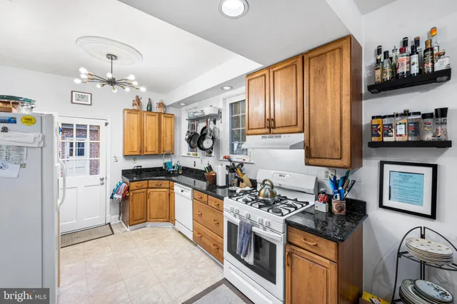 a kitchen with stainless steel appliances granite countertop a stove sink and cabinets