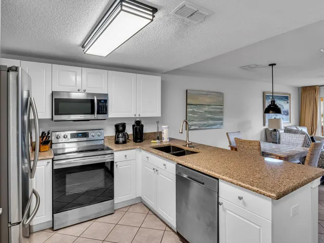 a bedroom with a bed and a flat tv screen on dresser
