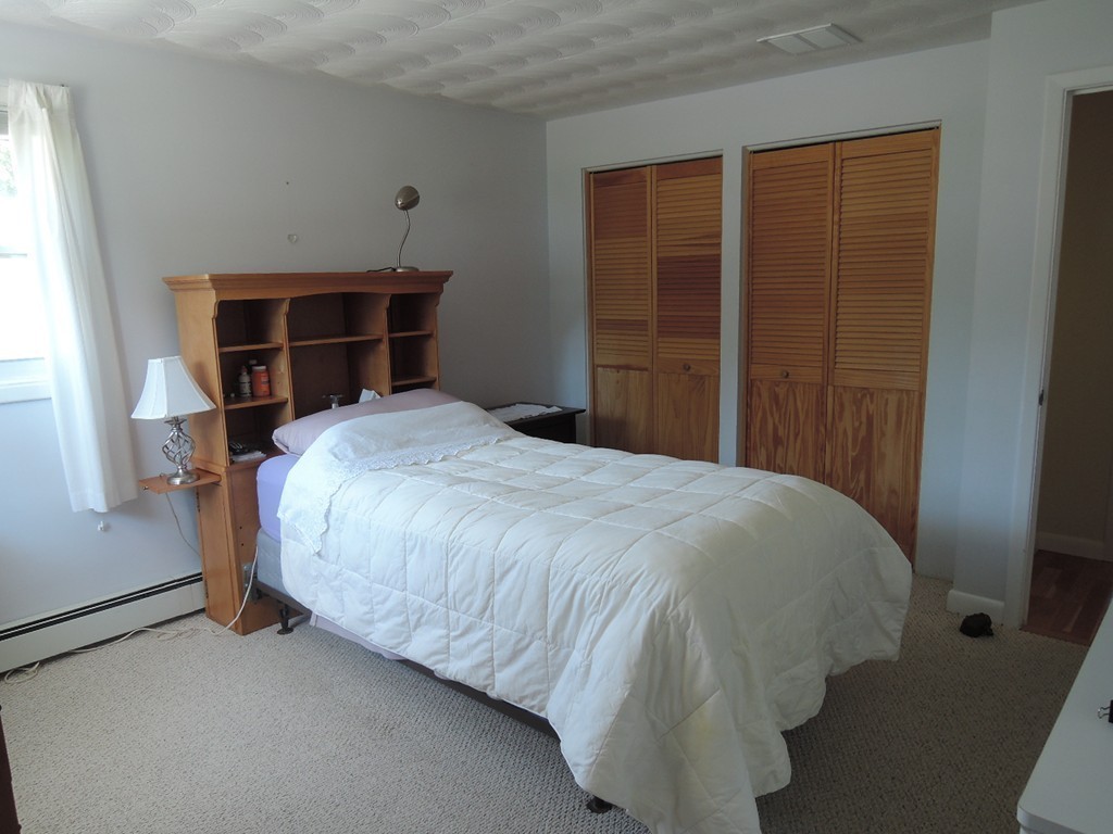 5 Temi Road Framingham, MA 01701 - Photo 14 of 27 a bed sitting in a bedroom next to a window