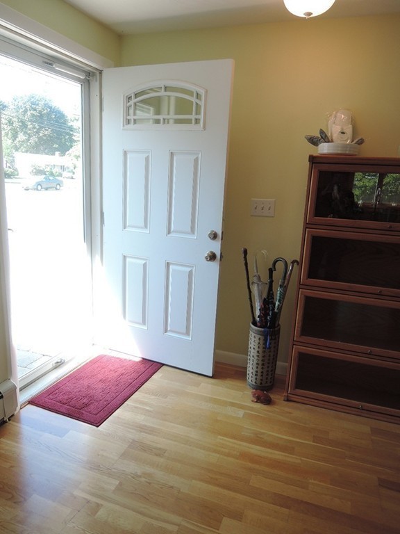 5 Temi Road Framingham, MA 01701 - Photo 3 of 27 a view of a livingroom with wooden floor and a potted plant