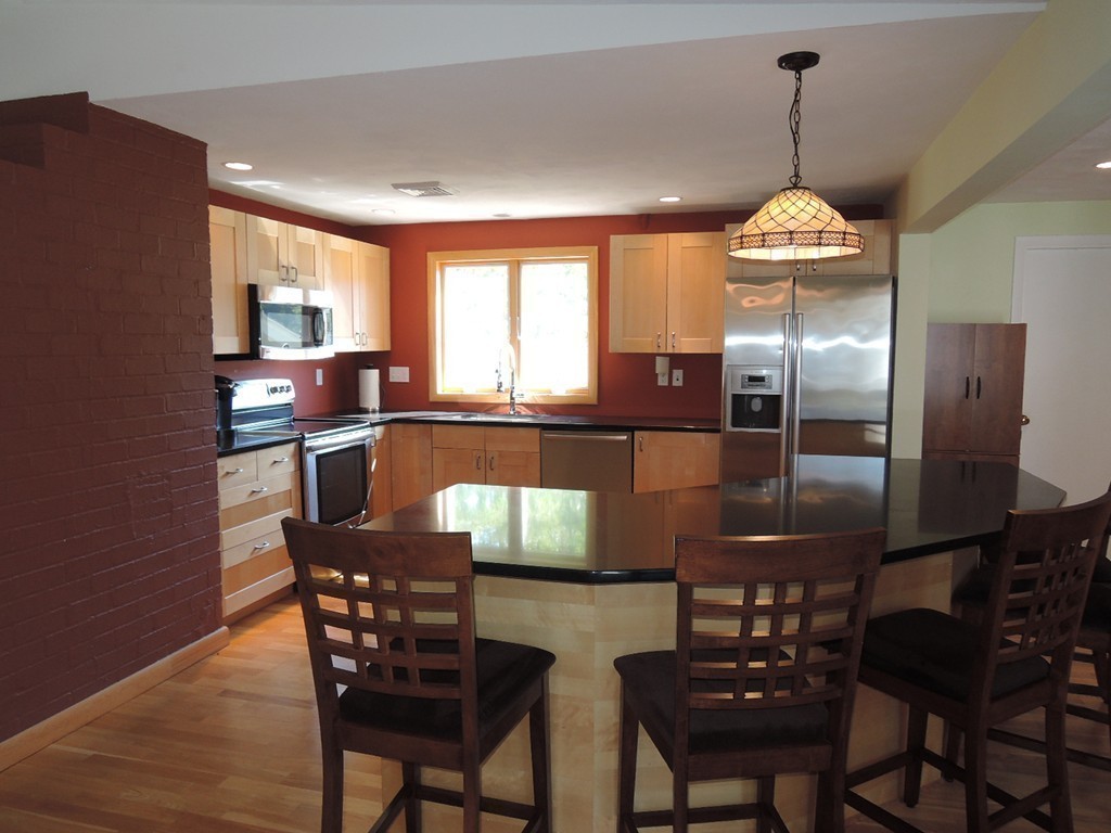 5 Temi Road Framingham, MA 01701 - Photo 7 of 27 a kitchen with granite countertop stainless steel appliances a table and chairs