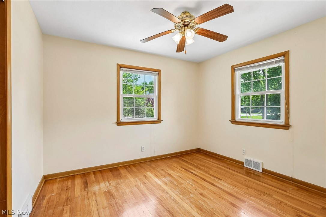 1638 South Cleveland Massillon Road Akron, OH 44321 - Photo 18 of 37 Room featuring wood-finish flooring, light-colored walls, and two windows with wood trim