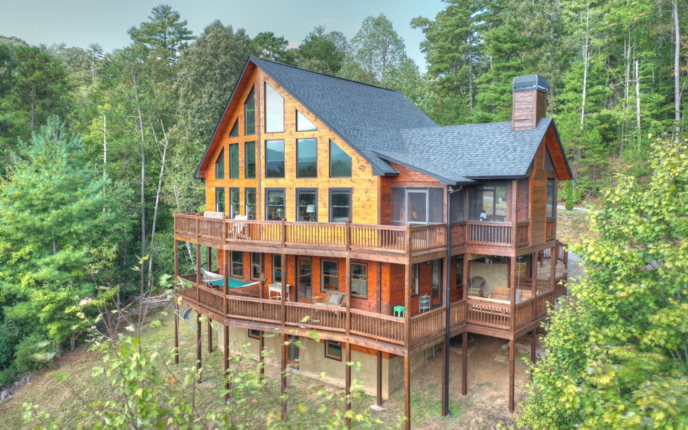 507 Tall Timber Mountain Road Blue Ridge, GA 30513 - Photo 1 of 1 a view of a large building next to a yard