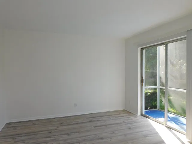 a view of an empty room and wooden floor