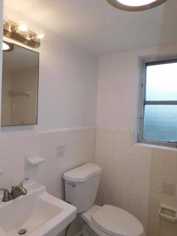 a white toilet sitting next to a bathroom sink