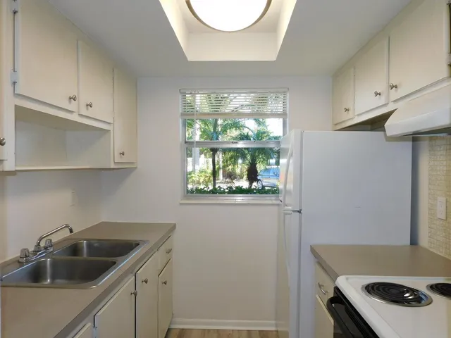 a kitchen that has a sink and a stove