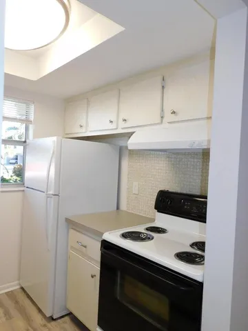 a kitchen with a stove and a refrigerator