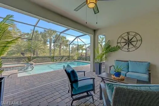 a dining room with furniture and a floor to ceiling window
