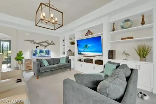 a living room with furniture kitchen view and a large window