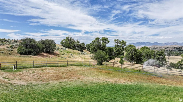 3123 East Riverdale Road Preston, ID 83263 - Photo 50 of 52 Expansive grounds featuring a wood-rail fence, mature trees, and distant mountain ranges