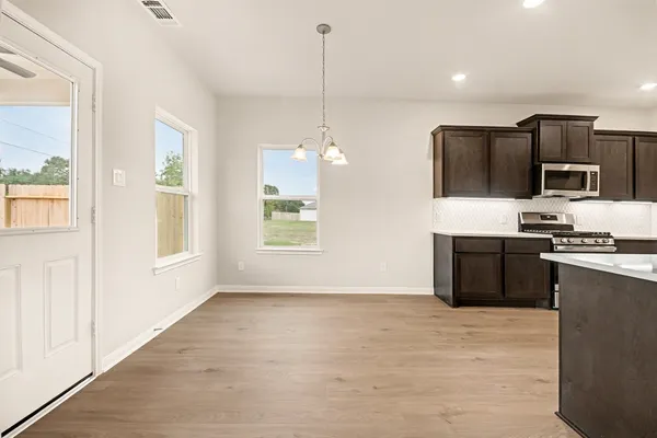a kitchen with kitchen island a counter top space appliances and a window