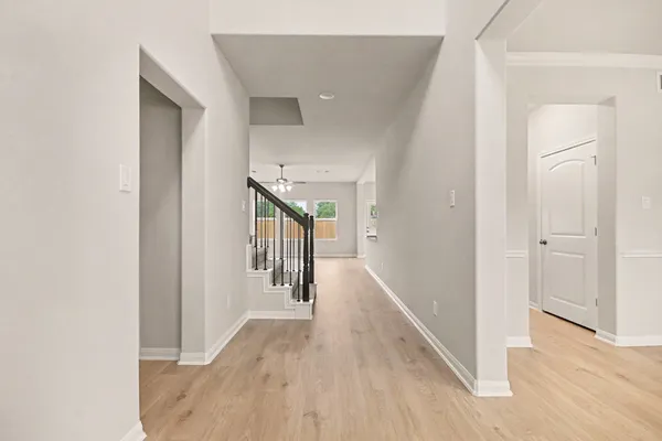 a view of a hallway with wooden floor