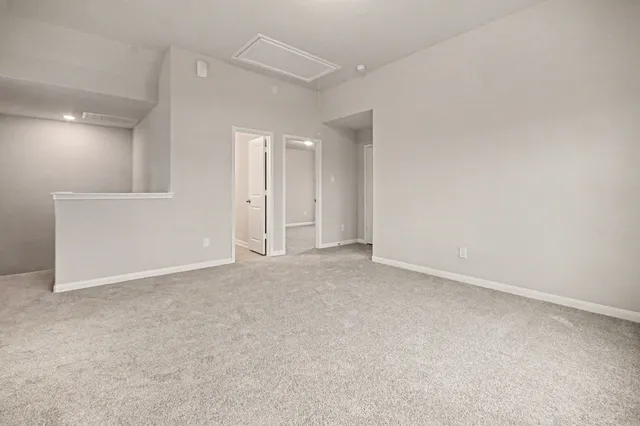 an empty room with a cabinet and mirrors