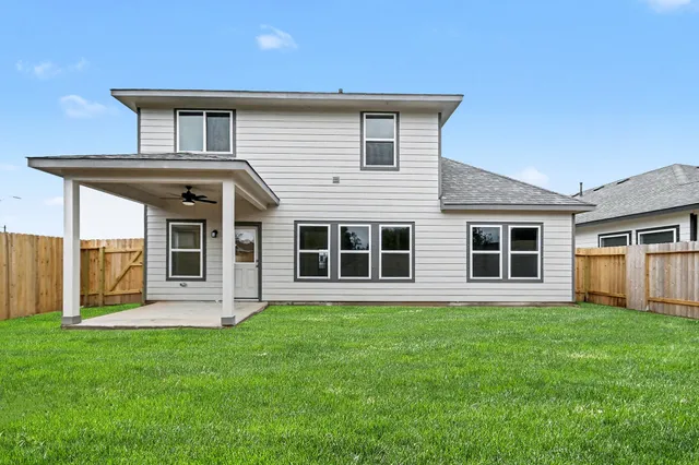 a big house with a big yard and large trees
