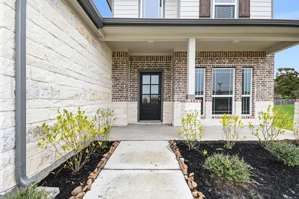 a front view of a house with outdoor seating and a potted plant