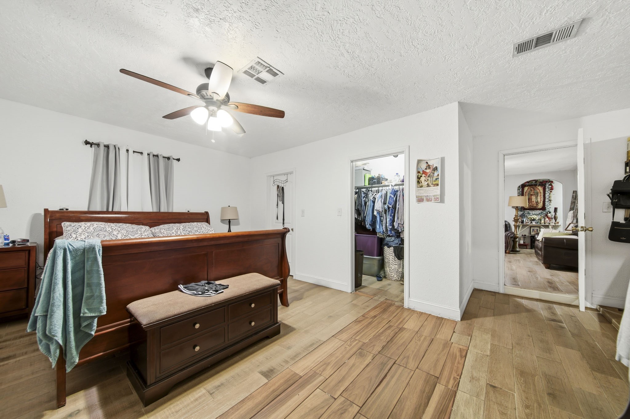 731 Meneley Road Winnie, TX 77665 - Photo 14 of 27 a bedroom with a bed and a chandelier